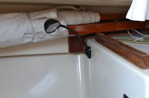 The dinghy gear is held in place with strap eyes and small stuff.  Reorienting the spars and retying the lines made room for the light.