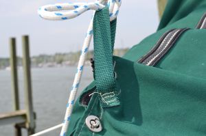 Webbing sewn into one side of the bag - not one end on either side of the bag - that would have made stowing the sail very difficult.
